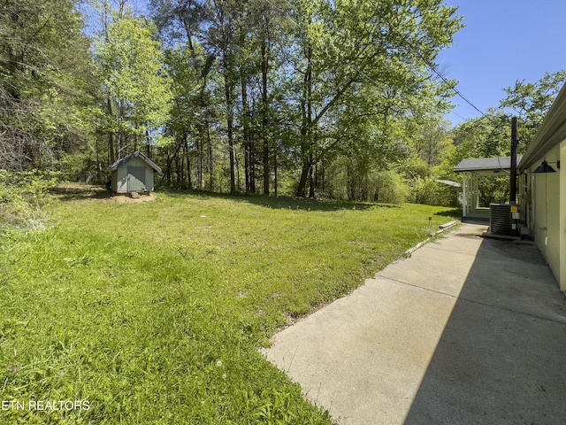 view of yard featuring a shed, an outbuilding, and cooling unit