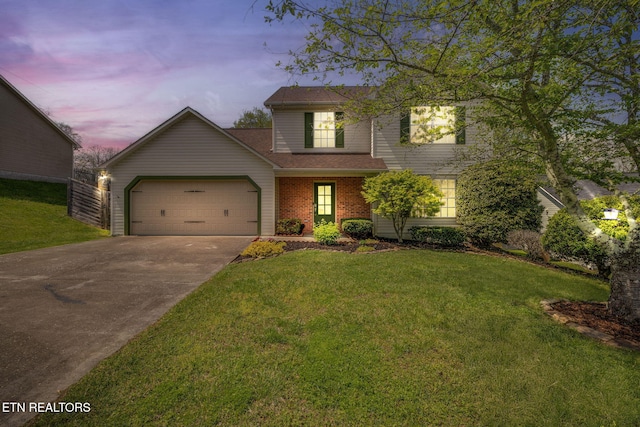 traditional-style home with a front yard, an attached garage, brick siding, and driveway