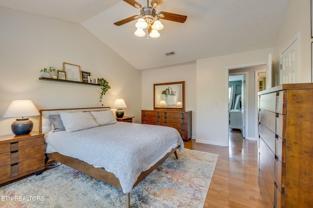 bedroom featuring lofted ceiling, a ceiling fan, light wood-style flooring, baseboards, and visible vents