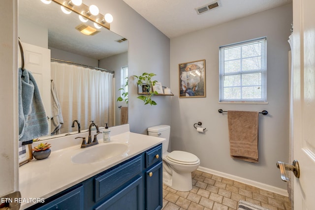 full bathroom featuring toilet, plenty of natural light, baseboards, and visible vents