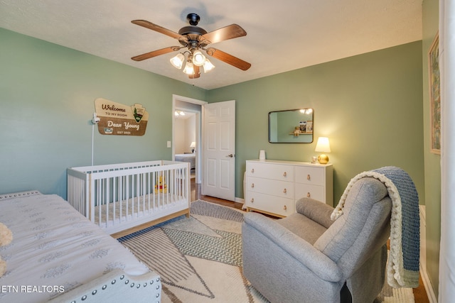 bedroom featuring baseboards and ceiling fan