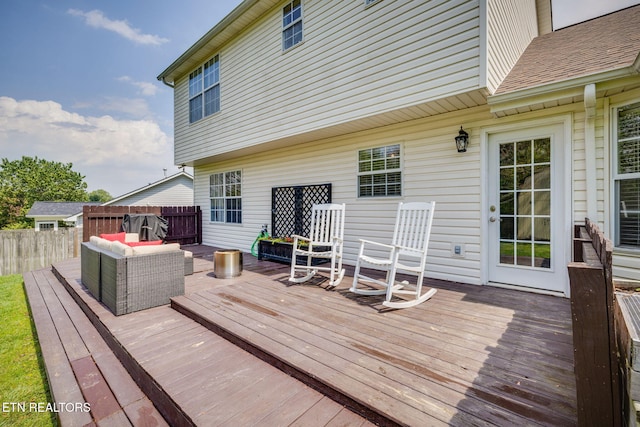 deck featuring fence and an outdoor living space