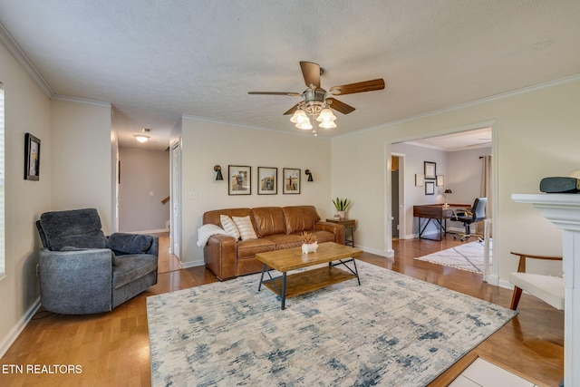 living room with ceiling fan, baseboards, and light wood finished floors
