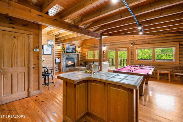kitchen with tile countertops, open floor plan, wood ceiling, and light wood-type flooring