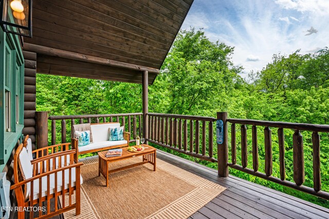wooden deck with an outdoor living space