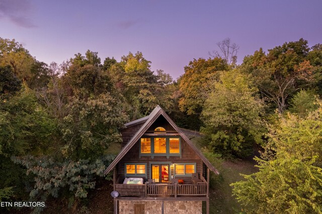 back of property with a forest view