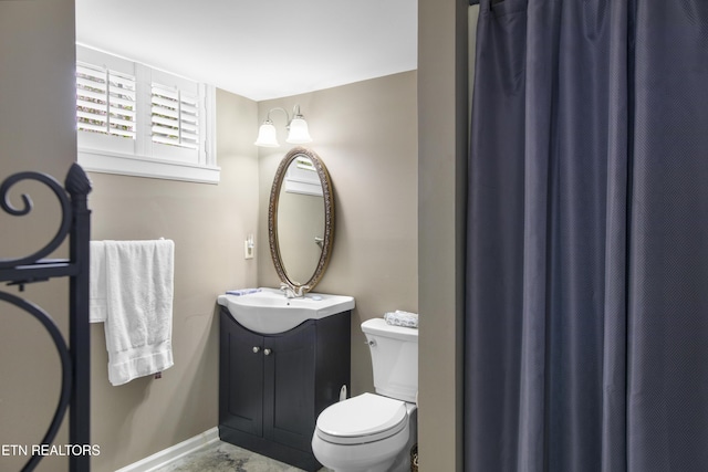 bathroom with toilet and vanity