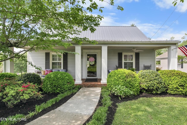 bungalow with ceiling fan, covered porch, and metal roof