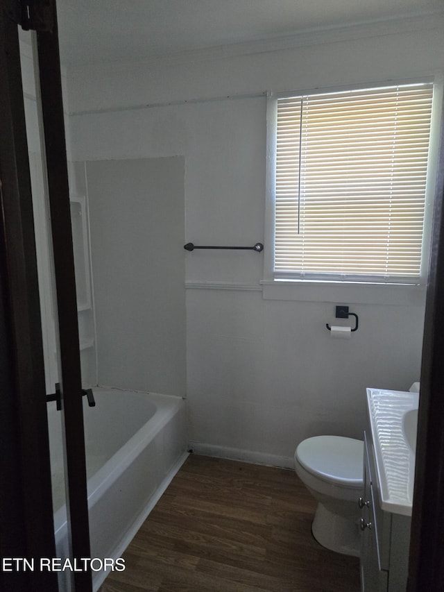 full bathroom with vanity, toilet, baseboards, wood finished floors, and ornamental molding