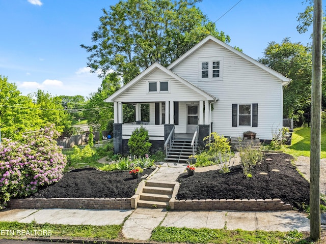 bungalow-style home with covered porch and stairway