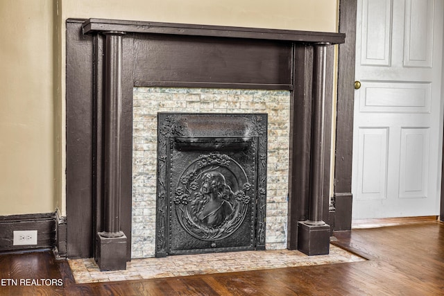 room details with wood finished floors and a fireplace