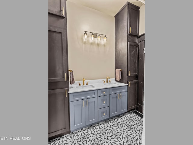 bathroom featuring double vanity, tile patterned floors, and a sink