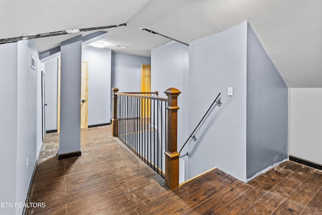 bonus room with baseboards and wood finished floors