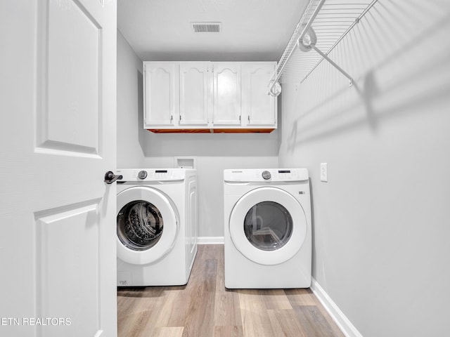 380 Buster Blvd, Lenoir City, TN 37772 - washroom with independent washer and dryer, visible vents, cabinet space, baseboards, and light wood-style flooring