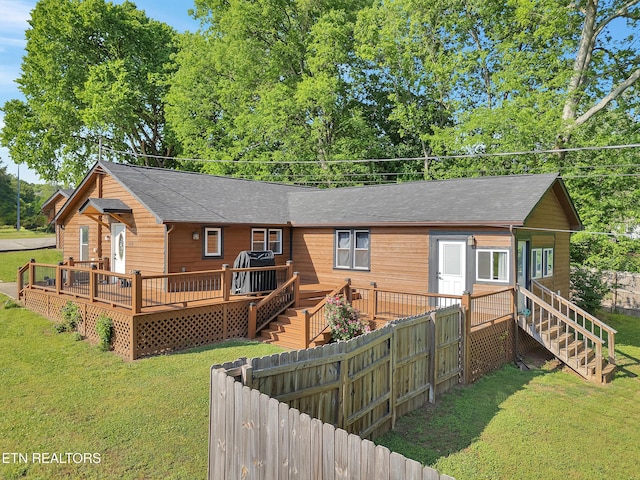380 Buster Blvd, Lenoir City, TN 37772 - back of property featuring a yard, a deck, fence, and a shingled roof