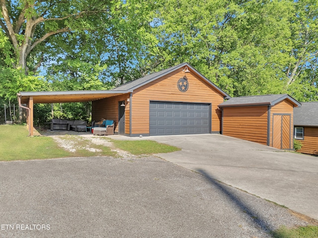 380 Buster Blvd, Lenoir City, TN 37772 - view of front of home with a detached garage, an outbuilding, an outdoor living space, and a shed