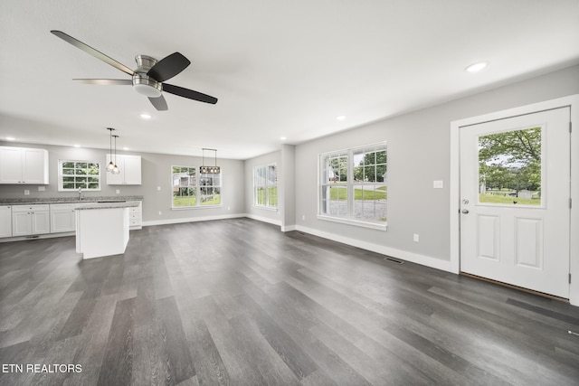 2934 Eledge Ln, Sevierville, TN 37876 - unfurnished living room with recessed lighting, dark wood finished floors, baseboards, a ceiling fan, and a sink