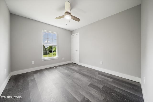 2934 Eledge Ln, Sevierville, TN 37876 - unfurnished room with dark wood-type flooring, a ceiling fan, and baseboards