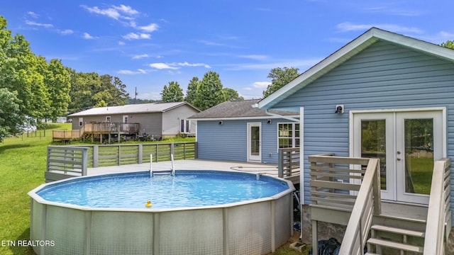 2934 Eledge Ln, Sevierville, TN 37876 - outdoor pool with a deck, a yard, and french doors