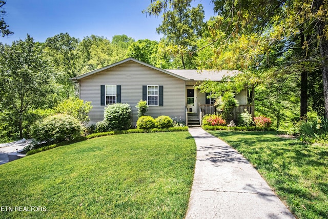 ranch-style home with a porch and a front yard