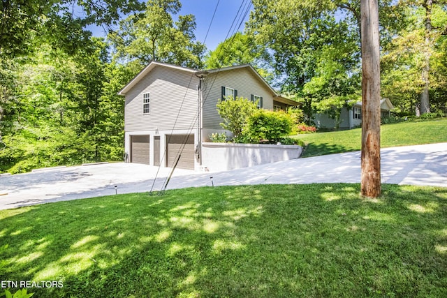 view of property exterior featuring concrete driveway, a lawn, and a garage