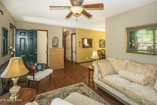 living area featuring baseboards, ceiling fan, and wood finished floors