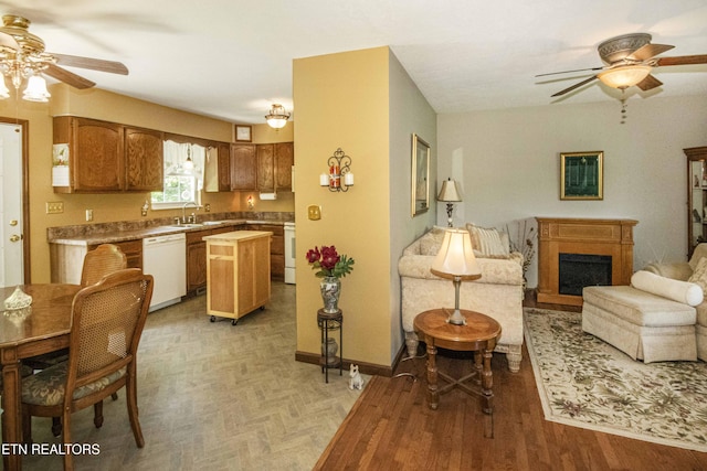 kitchen with a sink, ceiling fan, white appliances, and open floor plan