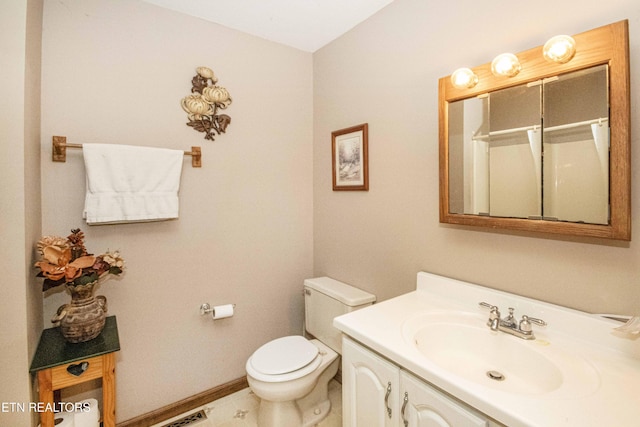 full bath with vanity, baseboards, and toilet