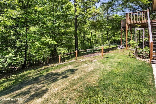 view of yard with a deck and stairs