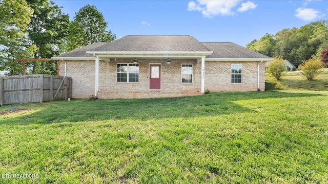 back of house with a lawn, fence, and a patio