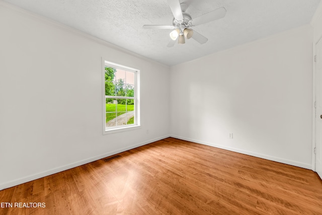 2208 Island Blvd, Sevierville, TN 37876 - unfurnished room featuring wood finished floors, crown molding, baseboards, ceiling fan, and a textured ceiling