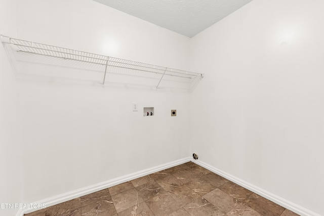 2208 Island Blvd, Sevierville, TN 37876 - laundry area featuring hookup for a washing machine, electric dryer hookup, baseboards, and dark stone finish flooring