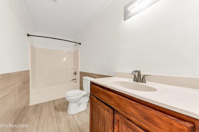 2208 Island Blvd, Sevierville, TN 37876 - full bath featuring toilet, vanity, tile walls, bathing tub / shower combination, and wainscoting