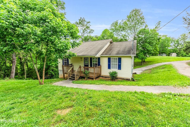 2208 Island Blvd, Sevierville, TN 37876 - view of front of house with a front yard, a shingled roof, and a porch