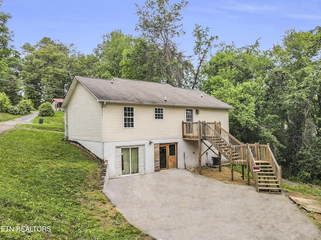 2208 Island Blvd, Sevierville, TN 37876 - back of house featuring stairway, a patio, central AC unit, a wooden deck, and a lawn