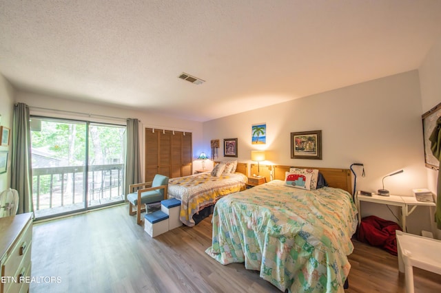 57 Eagle Ct, Crossville, TN 38558 - bedroom with access to outside, wood finished floors, and a textured ceiling
