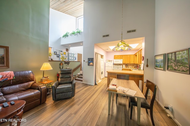 57 Eagle Ct, Crossville, TN 38558 - living room with a towering ceiling, light wood-type flooring, baseboards, and stairs