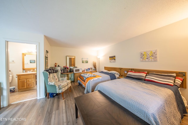 57 Eagle Ct, Crossville, TN 38558 - bedroom with wood finished floors, a sink, and connected bathroom