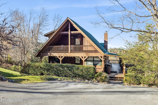 view of front of home with board and batten siding and a chimney