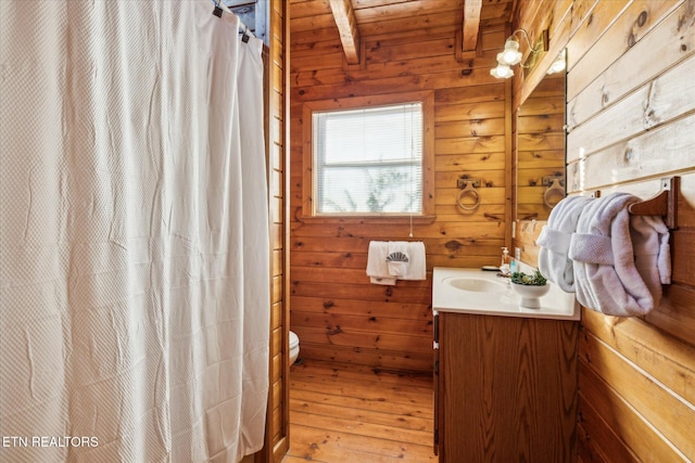 bathroom with vanity, hardwood / wood-style floors, toilet, wooden walls, and wood ceiling