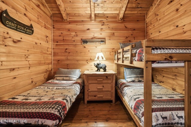 bedroom featuring wooden walls, beamed ceiling, wood ceiling, and wood-type flooring