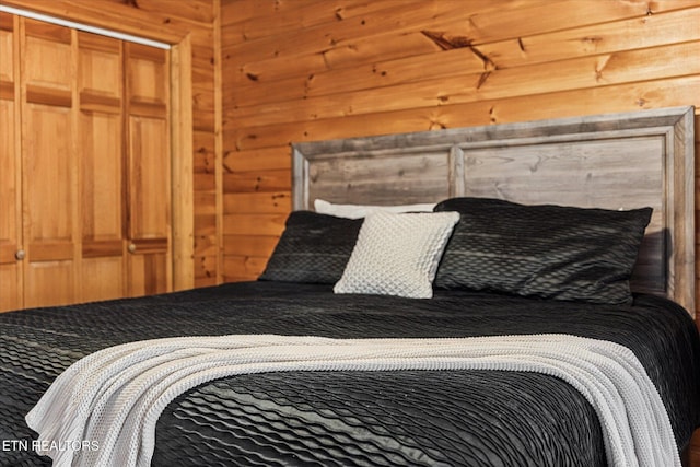 bedroom featuring wood walls