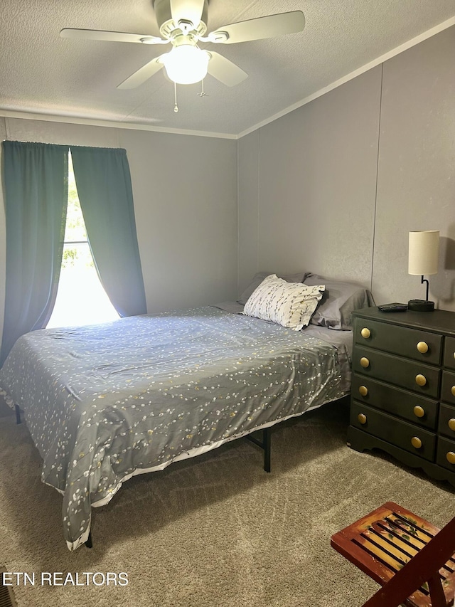 bedroom with ornamental molding, carpet, a textured ceiling, and ceiling fan