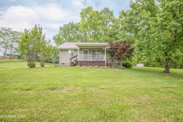 view of front of property featuring a porch, crawl space, metal roof, and a front yard