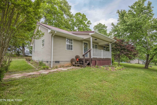 view of front of house with covered porch, a front lawn, and crawl space
