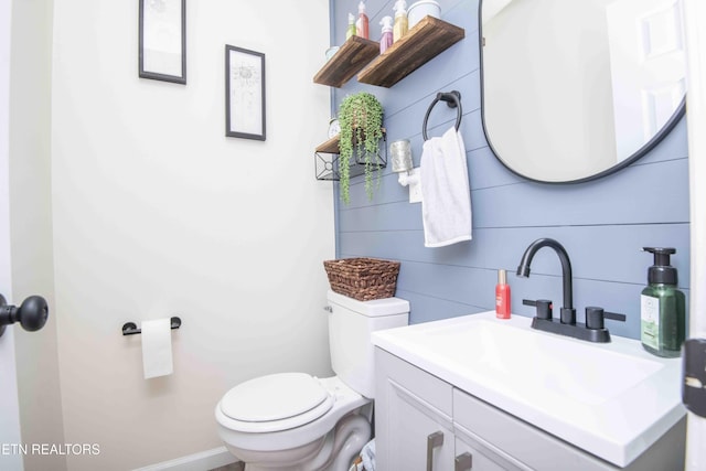 bathroom featuring toilet and vanity