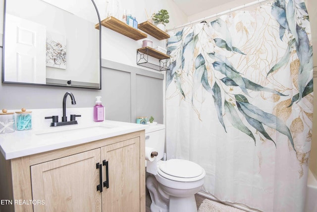 full bathroom with vanity, curtained shower, and toilet