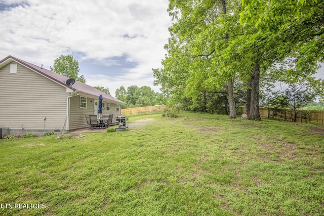 view of yard with fence and a patio