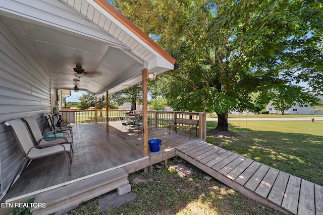 deck with a yard and a ceiling fan