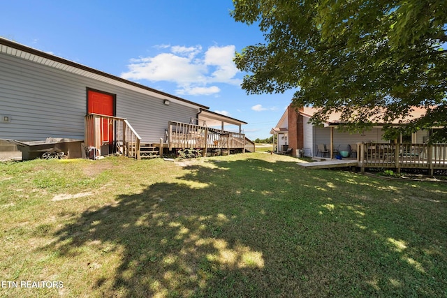 view of yard with a wooden deck